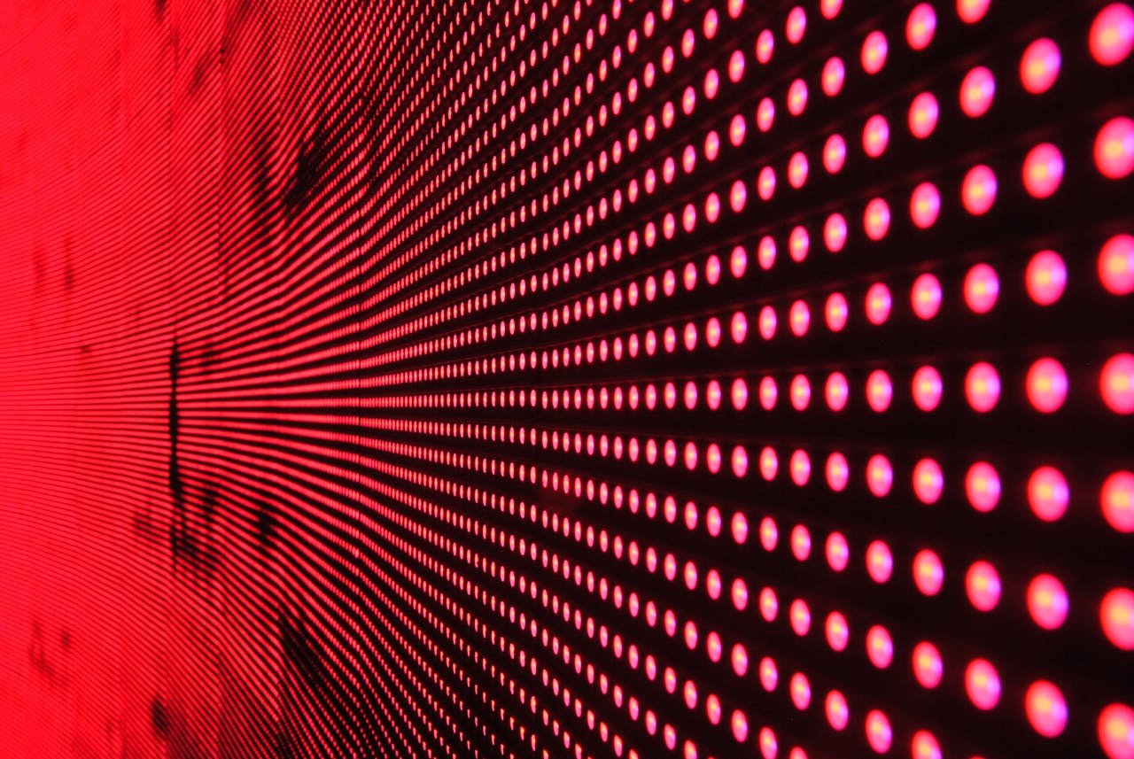 creative-03 Vibrant abstract pattern of illuminated red LED lights forming a dynamic design.